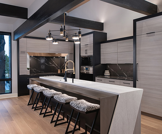Modern kitchen with quartz island, pendant lighting, and built-in appliances