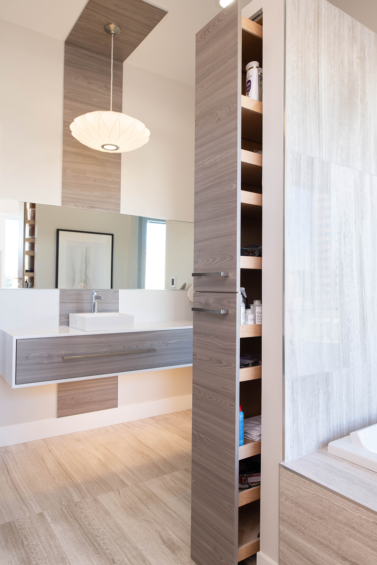 Spa-Inspired Bathroom Hidden pull-out storage cabinet beside soaking tub