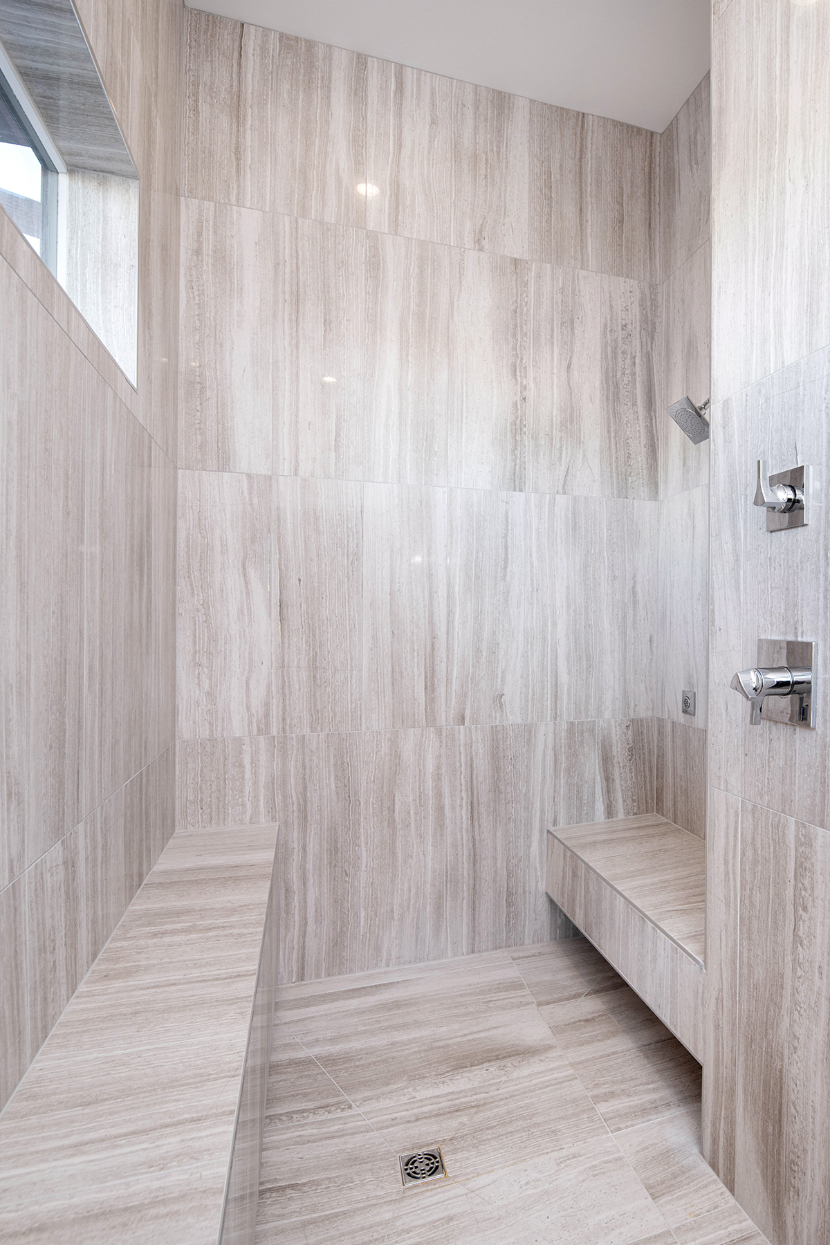 Luxury Walk-In Shower Luxury walk-in shower with floating bench and natural stone tile