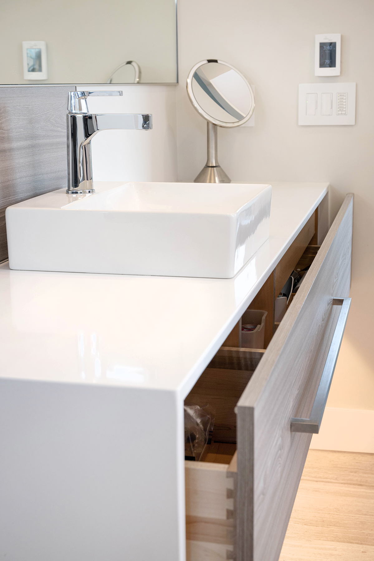 Hidden Pull-Out Storage Spa-inspired primary bathroom with weathered wood cabinetry and neutral finishes