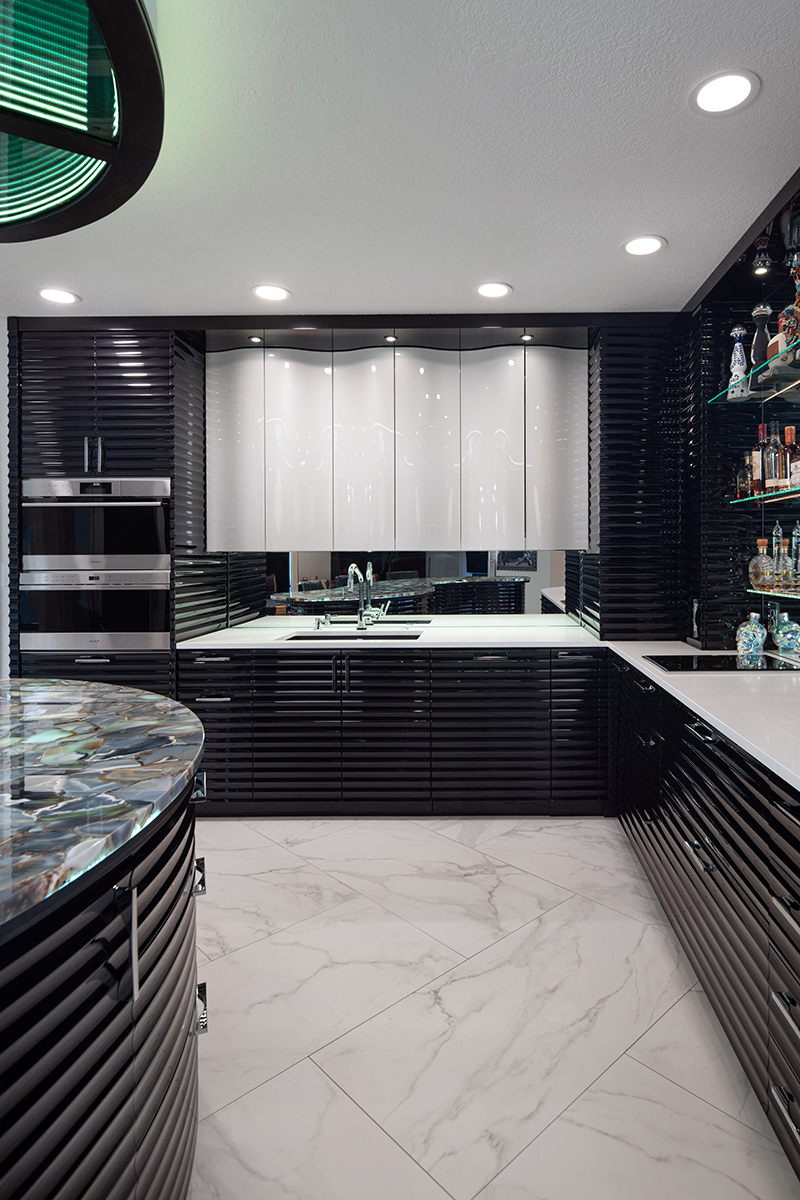 Kleweno-8757Kleweno custom basement bar and wine cellar High-gloss black custom cabinetry with brass hardware and premium finishes