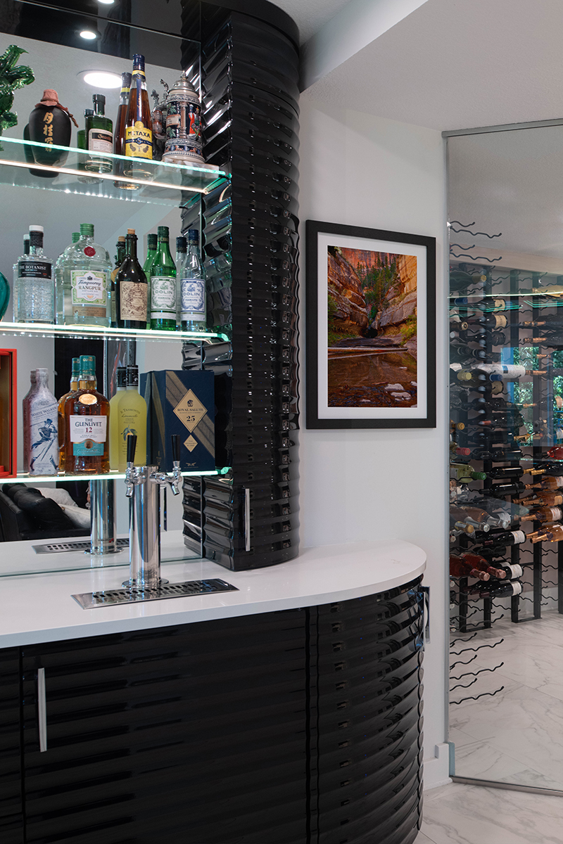 Kleweno custom basement bar and wine cellar Prep sink and workstation integrated into the custom entertaining bar
