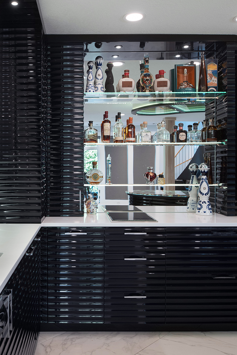 Kleweno custom basement bar and wine cellar Contemporary basement entertaining space with curved custom bar and glass wine cellar