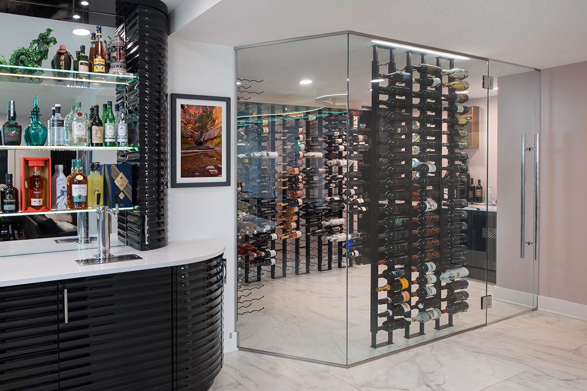 Kleweno custom basement bar and wine cellar Glass doors leading into a custom climate-controlled wine cellar