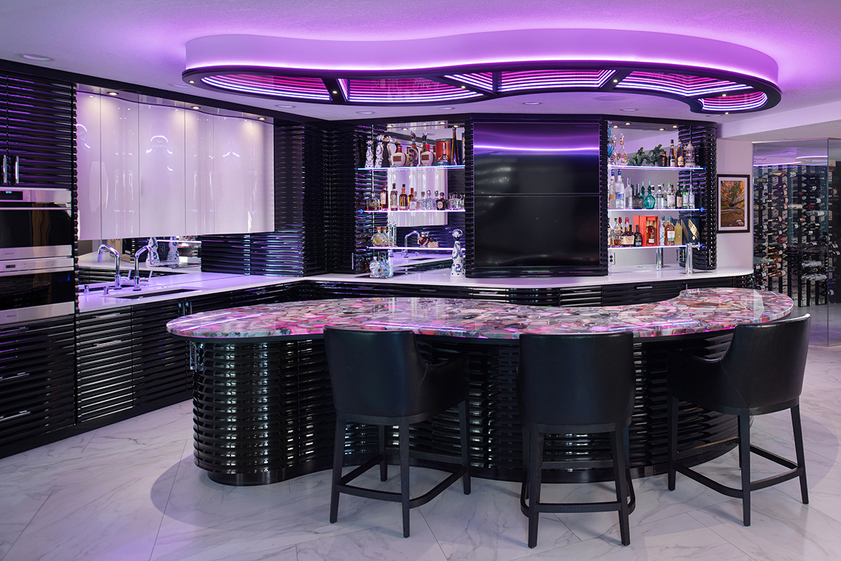 Kleweno custom basement bar and wine cellar Backlit sliced agate stone integrated into the custom basement bar island